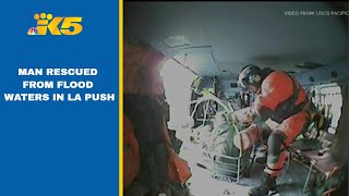 Man rescued after spending 12 hours trapped by flood waters