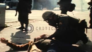 United States 3rd Infantry soldier attends to a wounded cameraman on street durin...HD Stock Footage