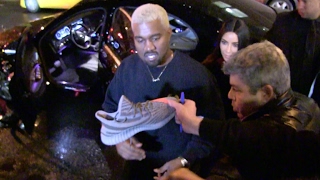 Total mess as kim kardashian and kanye west leave their apartment in
new york city on way to the yeezy season 5 after party. signs shoes
on...
