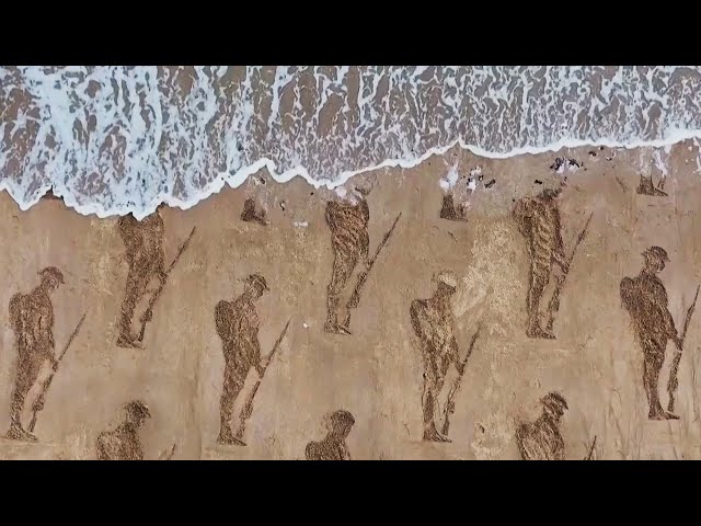 Soldiers Stenciled Into Sand for 80th Anniversary of D-Day class=