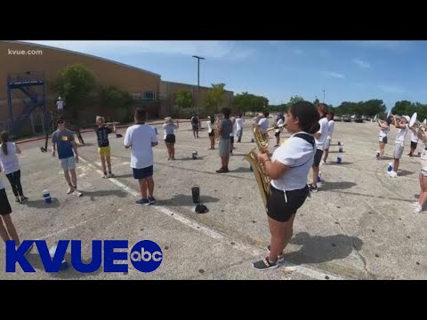 Akins High School marching band braves camp in the heat | KVUE