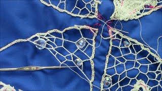 Butterfly suncatcher, a crochet lace background  with beads