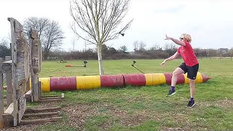 Man Displays Trick By Hitting Target After Throwing Three Axes Simultaneously Towards It - 1212091-2