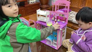 kids are playing with toy house models and egg hatchimals