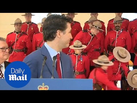 Two members of the Canadian Mounted Police faint behind Trudeau - Daily Mail
