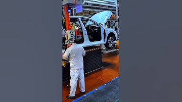 Fast-Paced Tire Installation on the Auto Assembly Line: Watch Skilled Workers in Action!