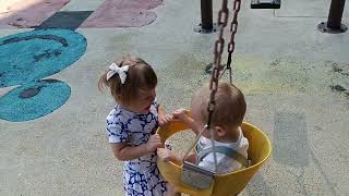 На качелях возле дома. On a swing near the house. Twins playing together. August 29, 2022.