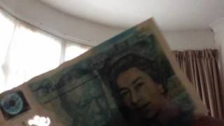 Testing the new five pound note.