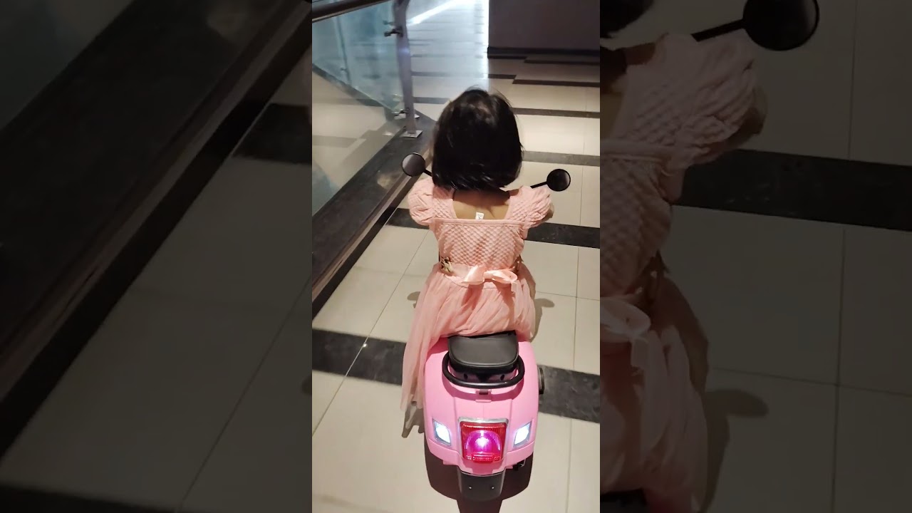 Perneet in pink Riding pink scooter