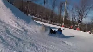 Snowboarder Rolling Over A Huge Tire In The Snow