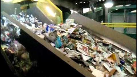 paper being sorted at a recycling sorting facility