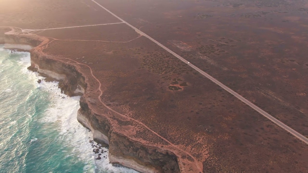 Camper van on empty coastal highway during a beautiful sunset FREE STOCK VIDEO