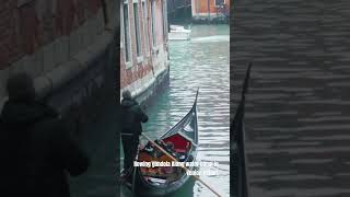 Rowing gondola Along water canal in Venice short