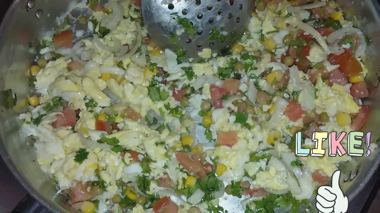 A plate of freshly cooked rice topped with fluffy scrambled eggs