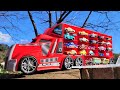 Minicar of various designs ride on large red trucks