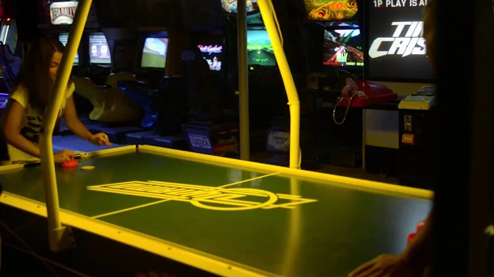 people play air hockey in the amusement park