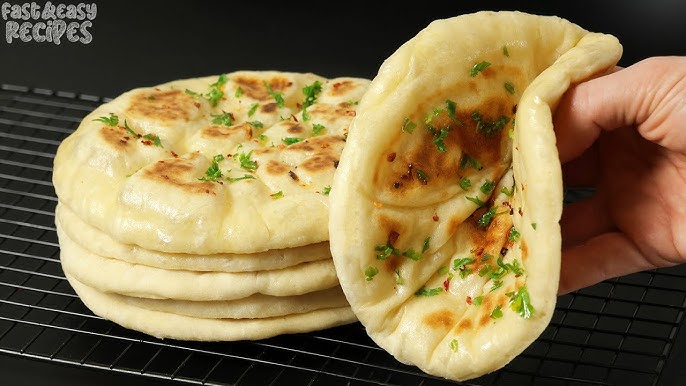 Naan Indian Bread Hand Made and Cooked in a Clay Oven in Old Spiltafields  Market, London 