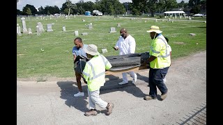 19 sets of remains exhumed from mass grave at Oaklawn Cemetery