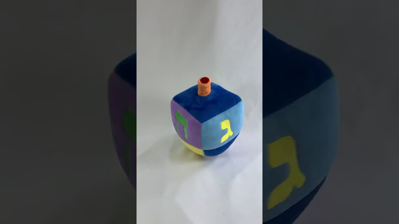 IT SWAYS, TILTS & SPINS WHILE PLAYING THE "DREIDEL SONG"