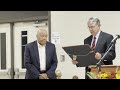 Dr. Gene Atkinson reads from the framed Citizen of the Year award to recipient Bennie M. Brown Jr.
