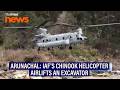 Indian Air Force's Chinook helicopter airlifts an excavator from a forward post in Arunachal