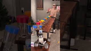 Guy Bounced Ping Pong Ball on Balloon Cups as a Water Bottle Slid across the Table