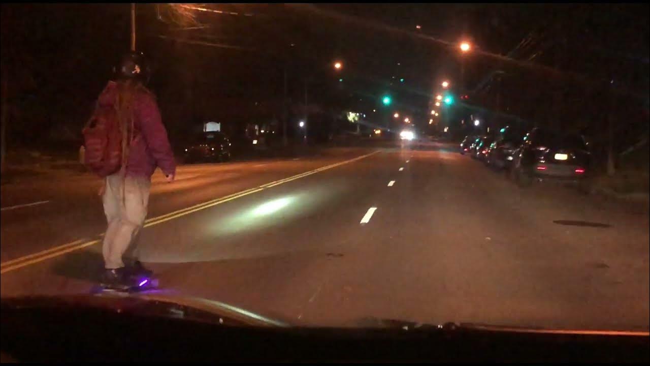 Dangerous Boy Roller skating in the Street at Night on his Skate Board