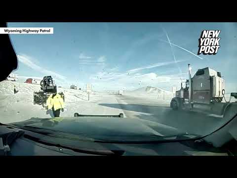 WATCH: Officer's narrow escape from truck skidding off snow-caked highway | New York Post