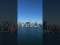 Still camera showcasing Toronto skyline with modern skyscrapers reflecting on Lake Ontario during a