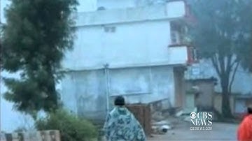 On tape: Building collapses into river
