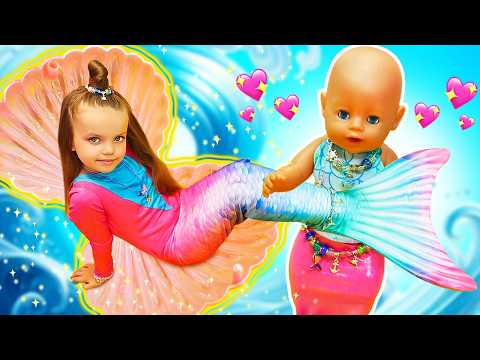 Maya and the baby doll pretend to be mermaids and have fun in the water pool.