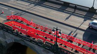 Damage after Police car left dangling over edge of bridge during emergency | SWNS