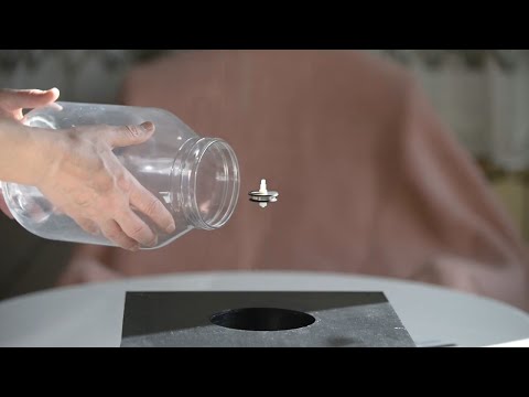 Magnetic levitation. Unboxing and putting a spinning top in a jar.