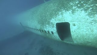 Underwater plane wreck freediving inside passenger cabin of The Lockhead L1011 TriStar plane.