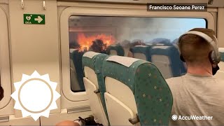 Halted train stuck with wildfires burning on both sides | AccuWeather