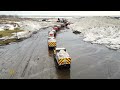Snowplow Video 27 - Bulldozers pushing snow hauled by queue of transport trucks