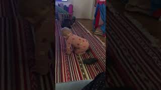 Woman uses laser pointer to play with baby but cat sees the red dot and hits baby on the head