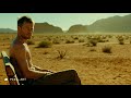 Melt it a man sitting on a bench in desert is sweating, so hot, the sun is shining about, nearly no