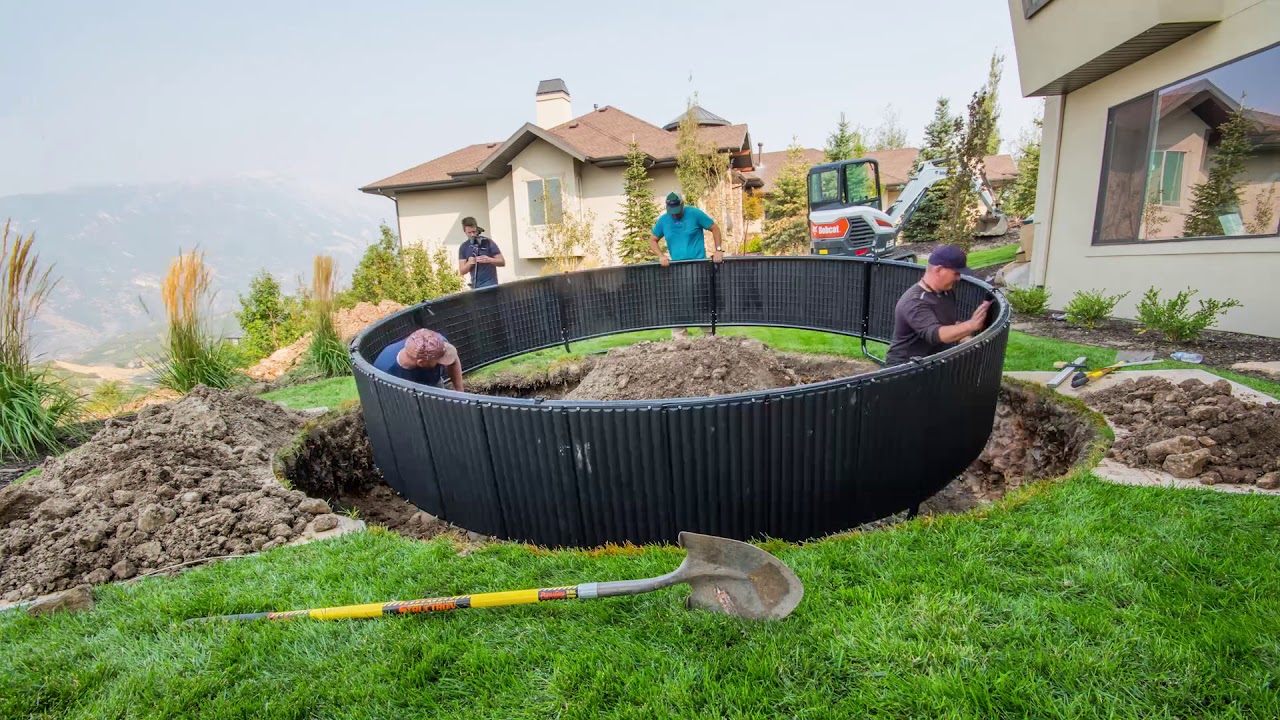 Workers installing an in ground trampoline.