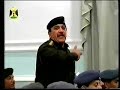 An officer recites poetry before leader Saddam Hussein