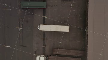 AERIAL: Birds Eye View of Cargo Truck loading area with crates and containers