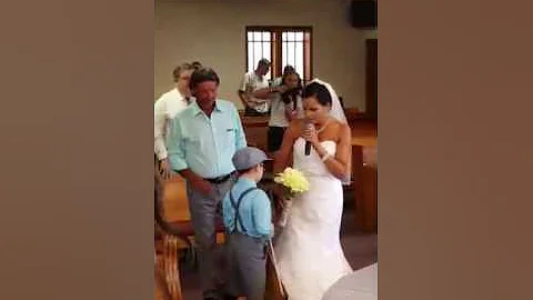 Bride singing as she walks down to her groom.