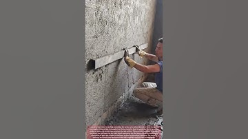Thumbnail of Construction Worker Smooths Fresh Mortar on Wall Using Thick Rectangular Tool