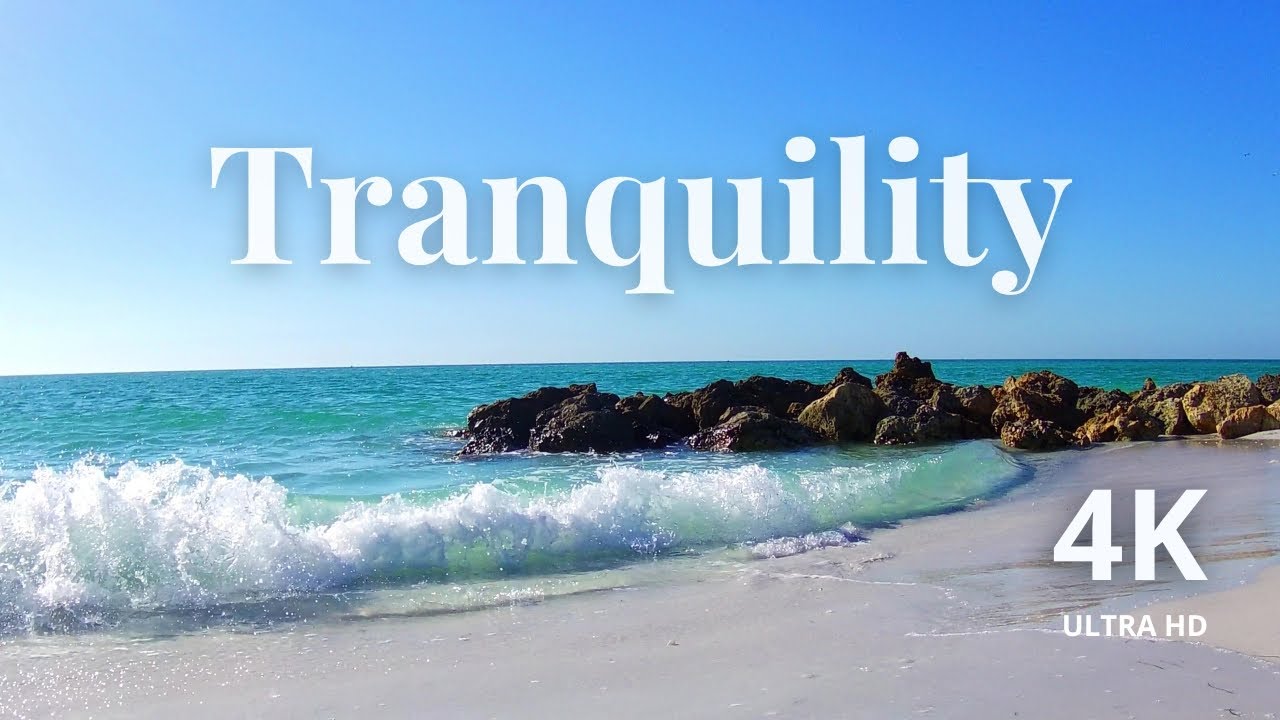 Tropical Crystal Clear Emerald Waves Crashing on White Sand Shore and Beach Rocks Nearby | 4K UHD