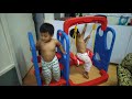 Two little monkey climbing on a slide