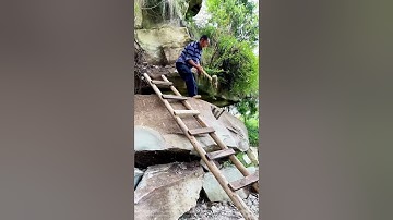 Workers use traditional methods to clear large rocks
