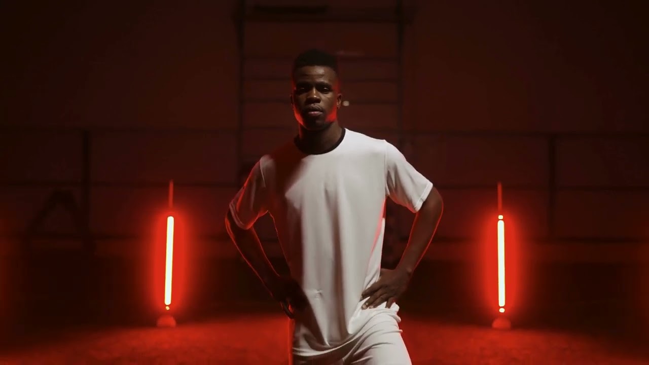 VideoVault Stock Video: Soccer player stands with his foot on the ball