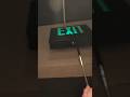 Testing a black housing green lettering Prescolite PEX exit sign