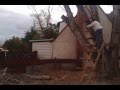 Rope breaks cutting hudge limb over house.