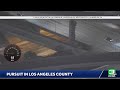 Law enforcement officials are chasing a vehicle across the San Fernando Valley in Los Angeles Cou...